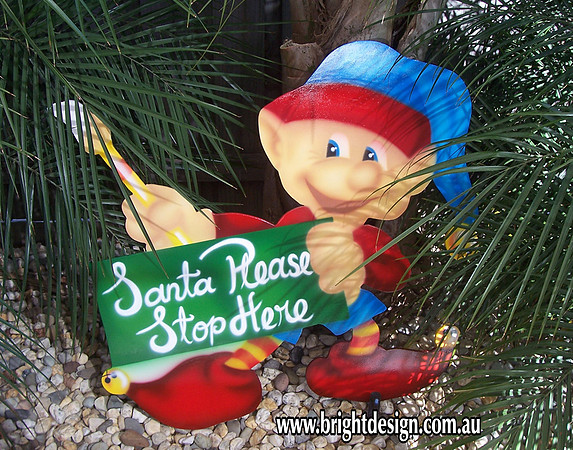 4- E-13 CG Santa Stop Here Paintng Elf Outdoor Christmas Cut Out in a Home Garden Christmas Display