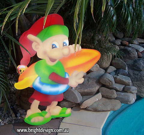 4- E-30 CG Surfboard Elf Outdoor Christmas Cut Out in a Home Garden Christmas Display